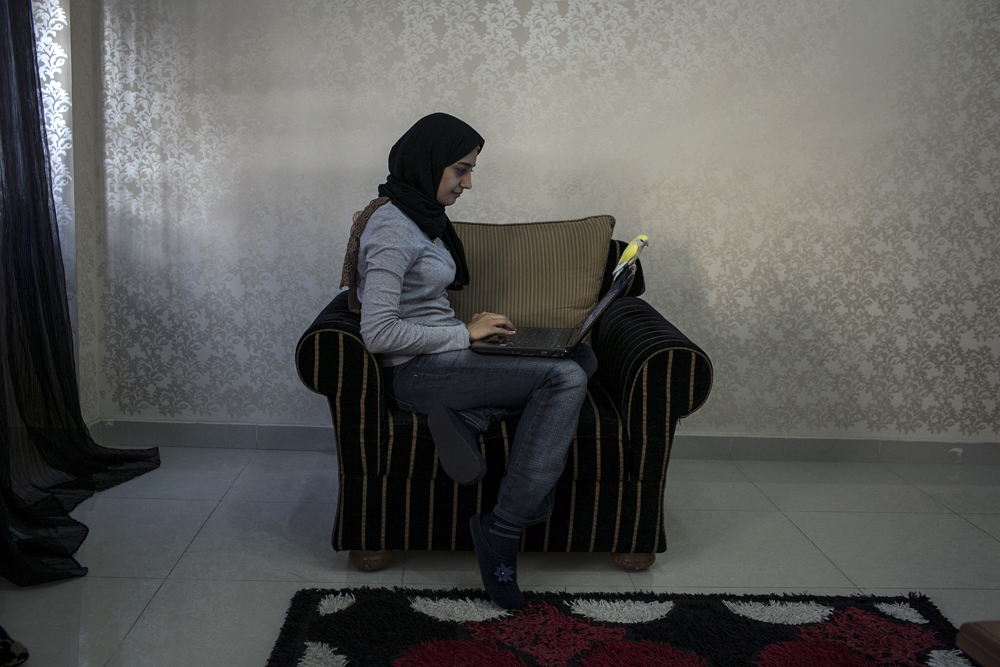 Jordan. Syrian refugee uses technology to stay connected to her work in Damascus