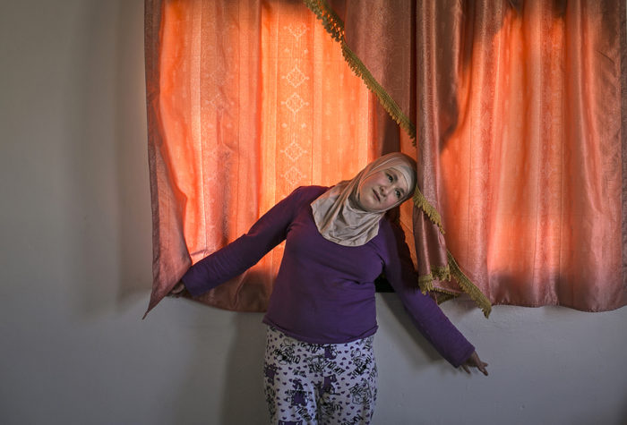 Jordan.  Mentally disabled twins pan handle in urban community to help sustain Syrian refugee family.